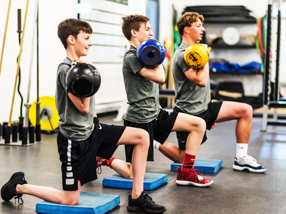 Image of three youth doing athletic training at Saltus Performances main gym in vancouver