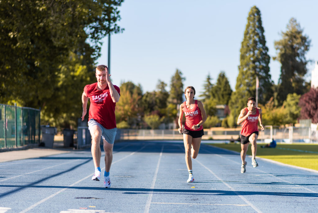 three members of the Saltus team running a track race