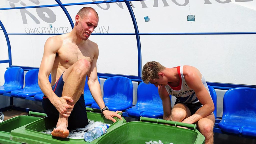 Image of two men doing ice and cold water therapy