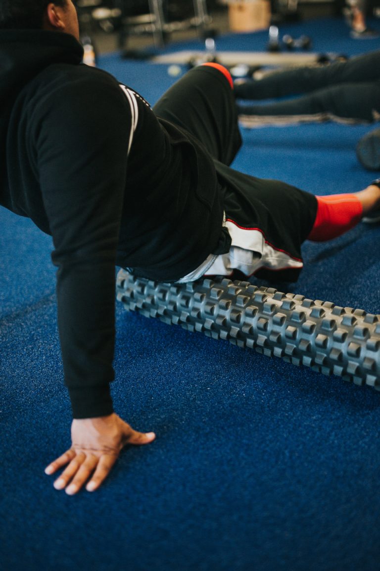 A image of a person foam rolling to help stretch their muscles.