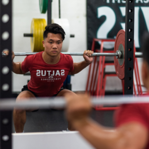 An athlete doing a squat at the Saltus Performance gym