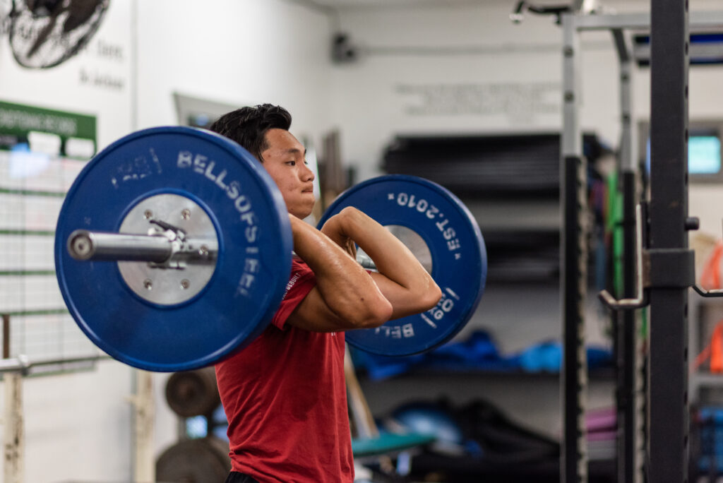 Image of an athlete performing an Olympic lift in the Saltus Performance gym.