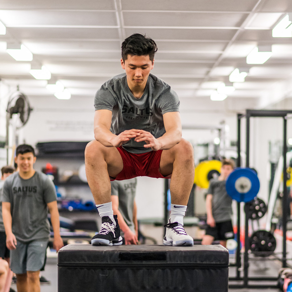 An athlete at saltus performing a box jump