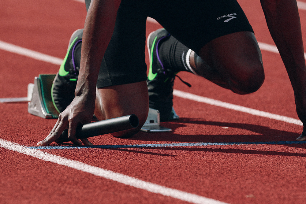 a runner waiting to explode out of their sprinting stance