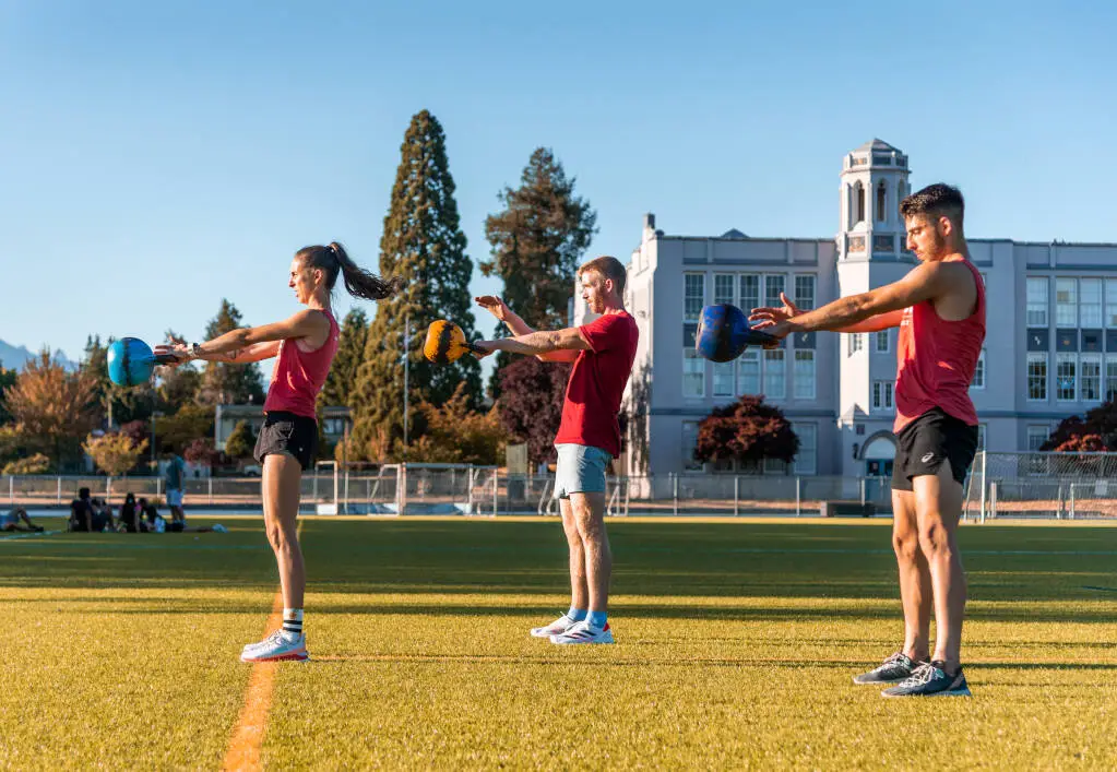 Banner image of group of people doing kettlebell swings at Saltus Performance