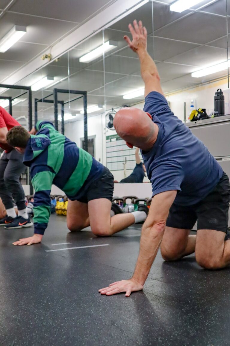 Image of a man doing a Dynamic Warm-Up. Done at Saltus Performance