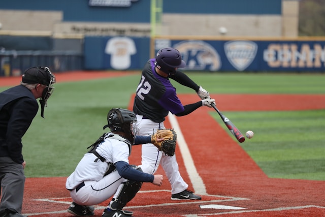 Someone hitting a baseball in a baseball game